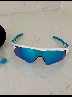 Oakley White Frame Sunglasses with Blue Lenses and Blue Temple Tips